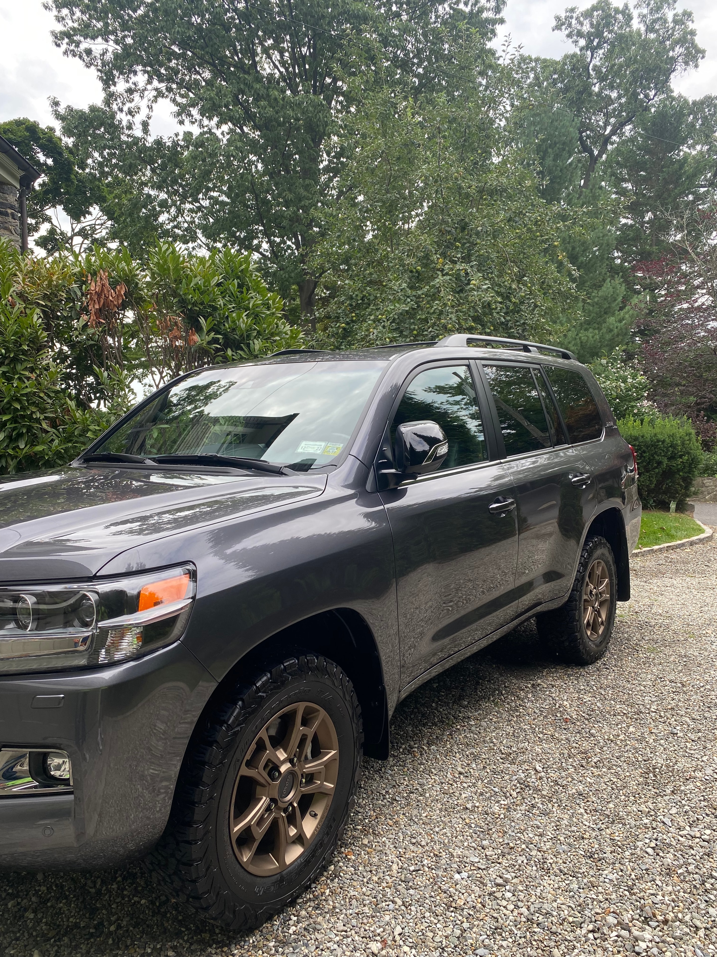 Dark gray Toyota Tacoma freshly detailed on a gravel driveway