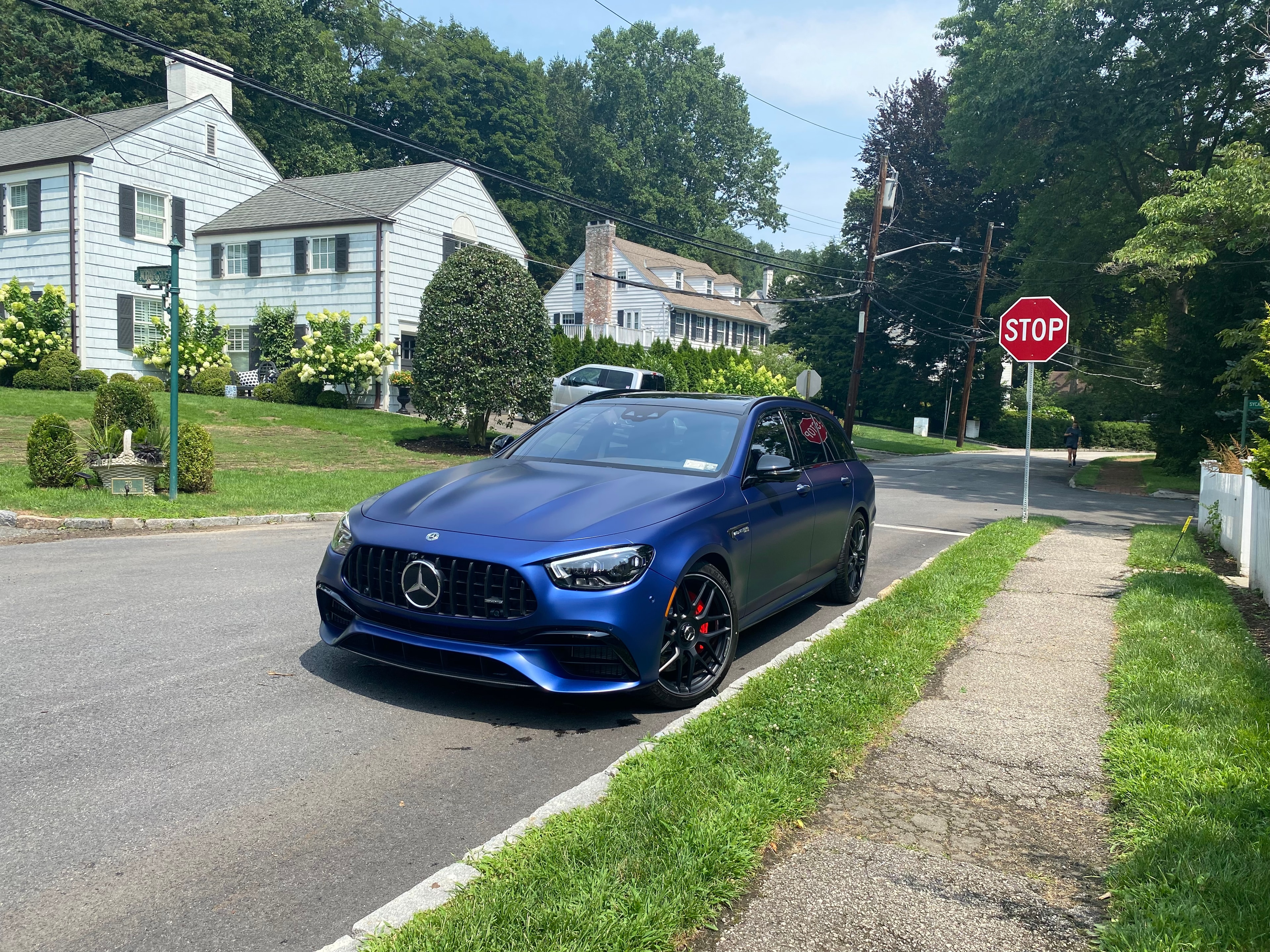 Matte blue Mercedes-AMG E63 wagon detailed on a Westchester neighborhood street